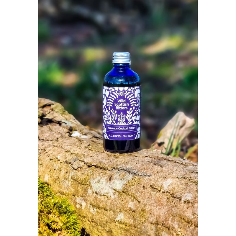 Highland Boundary Wild Scottish Bitters on top of a log in a forest