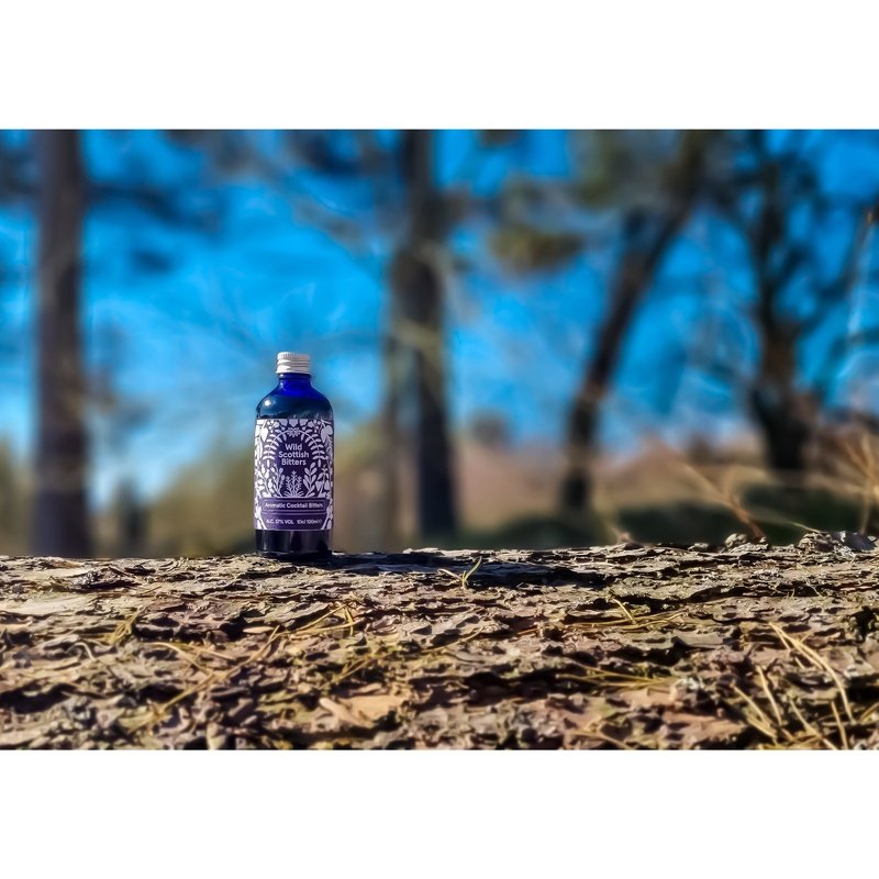 Wide view of Highland Boundary wild scottish bitters in front of trees in nature